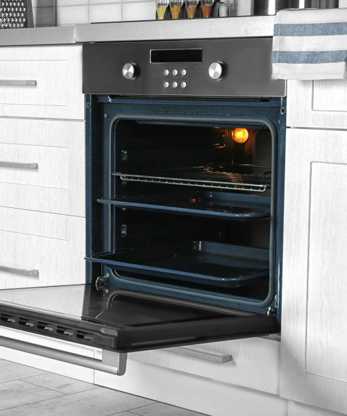 Perfectly cleaned, open oven in a bright kitchen